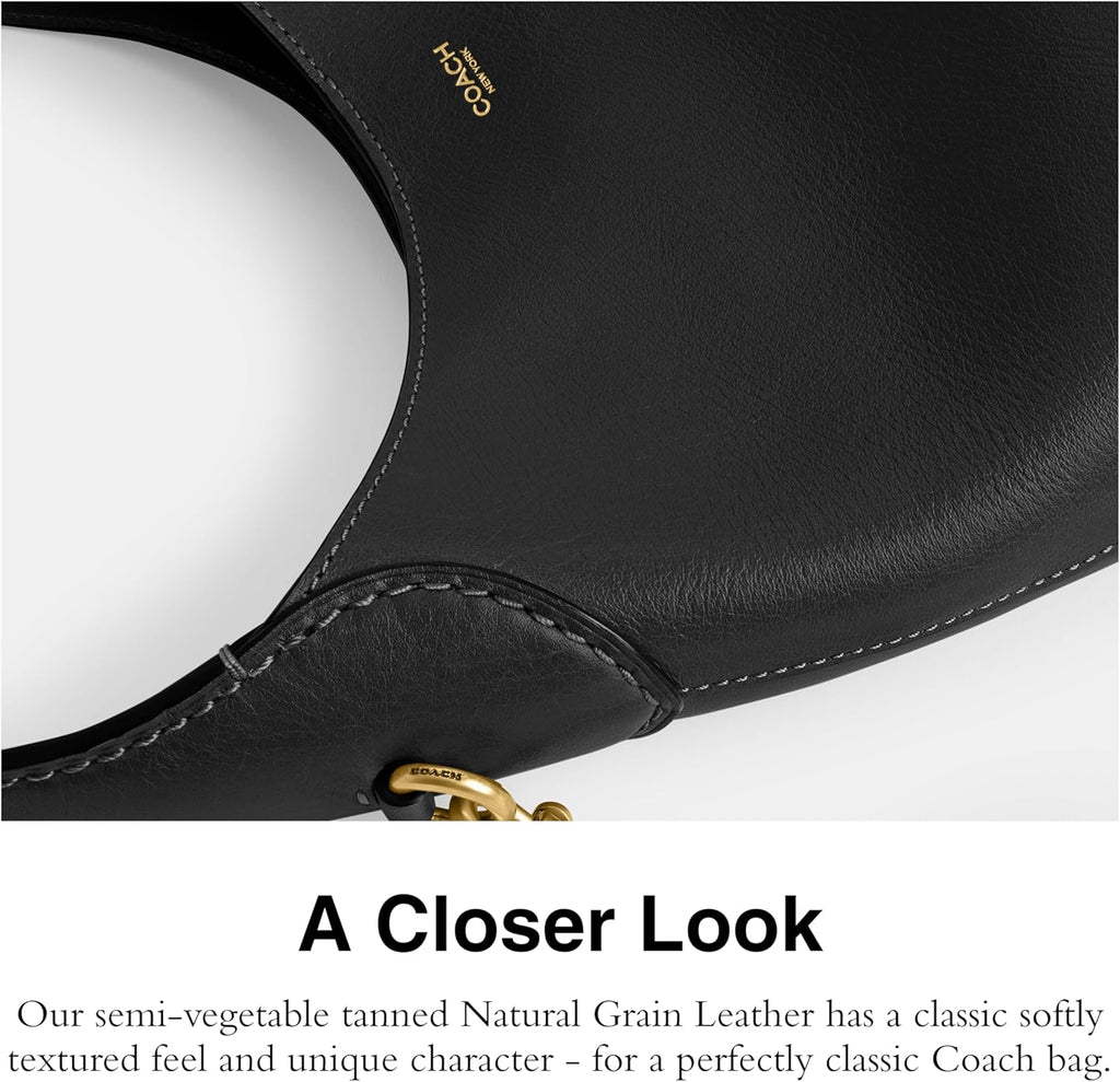 Black leather bag with stitched edge and gold-tone hardware detail near opening