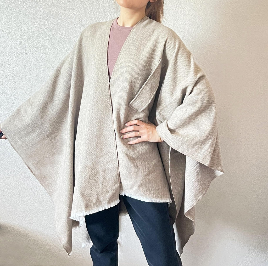 Light beige open-front fringe poncho shawl with long drape and tied front knot