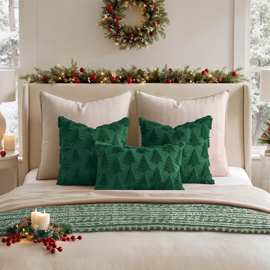 Green Christmas tree throw pillow covers on a bed with two white accent pillows