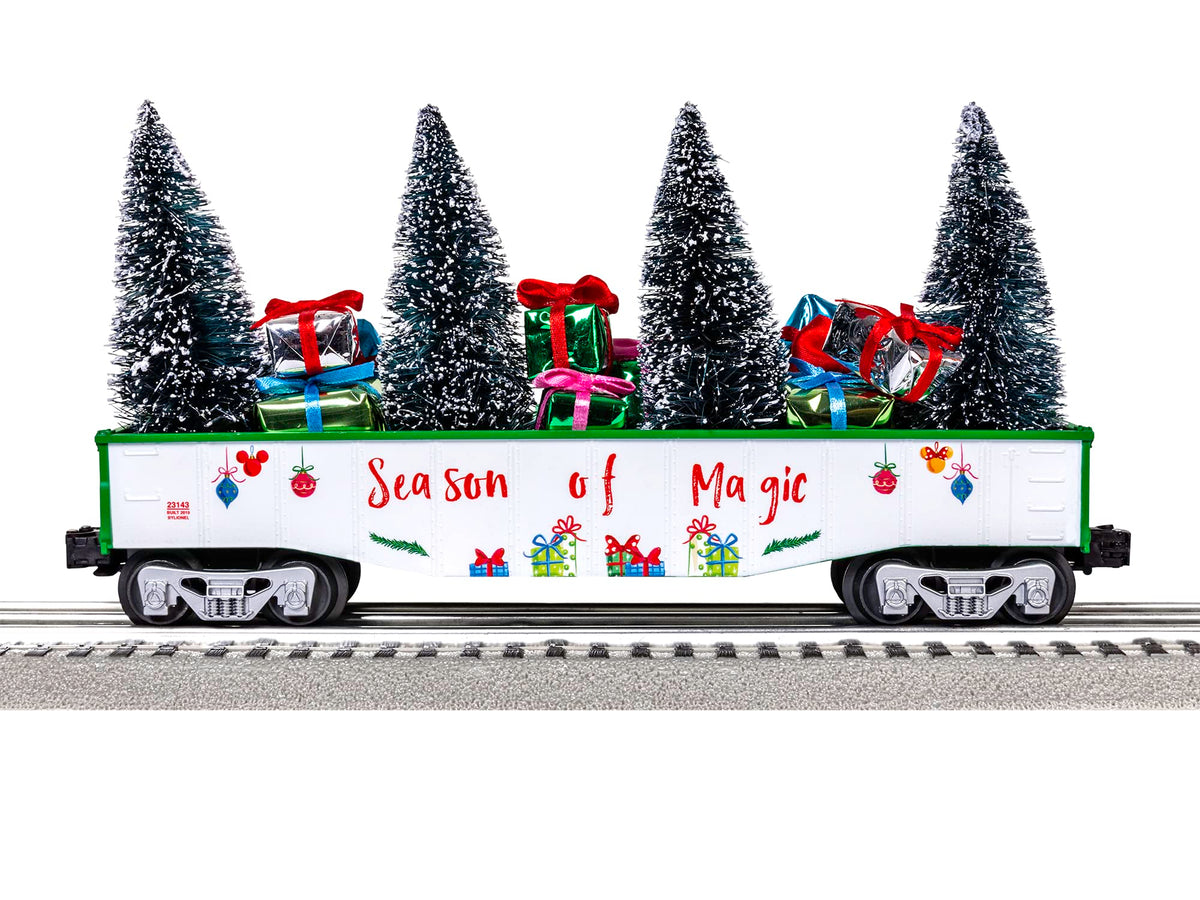 Decorated passenger train car with snowy trees and gift-themed graphics