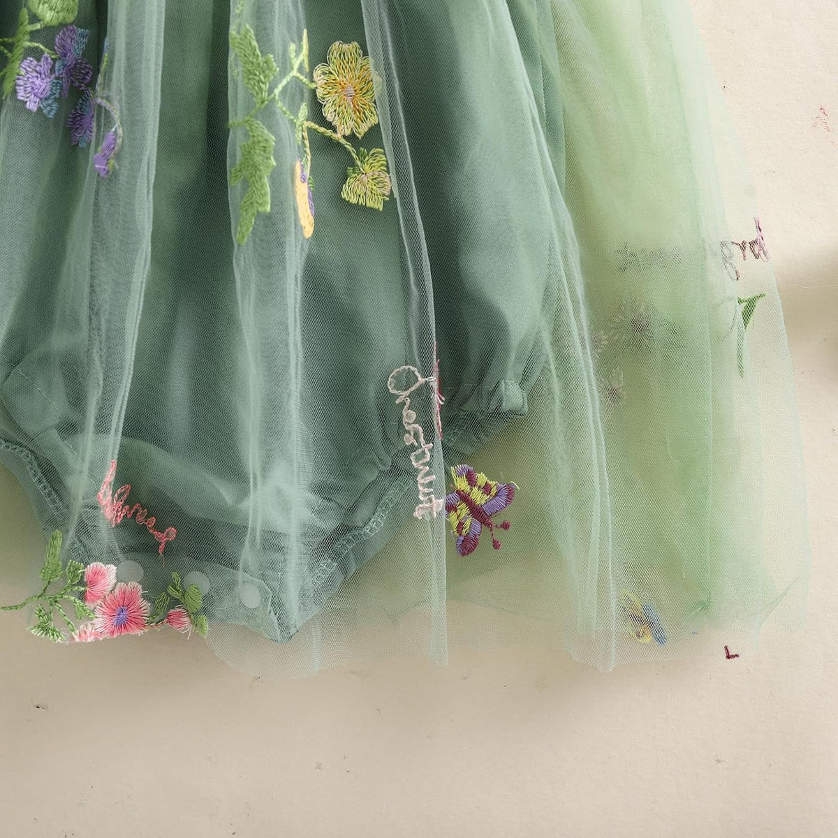 Green tulle skirt with colorful floral embroidery and delicate mesh overlay