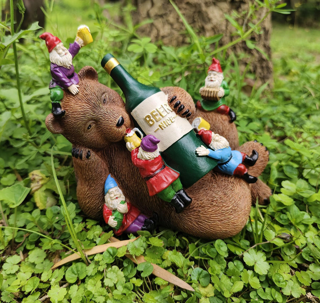Garden bear yard statue with gnome figurines sitting on a green beer bottle