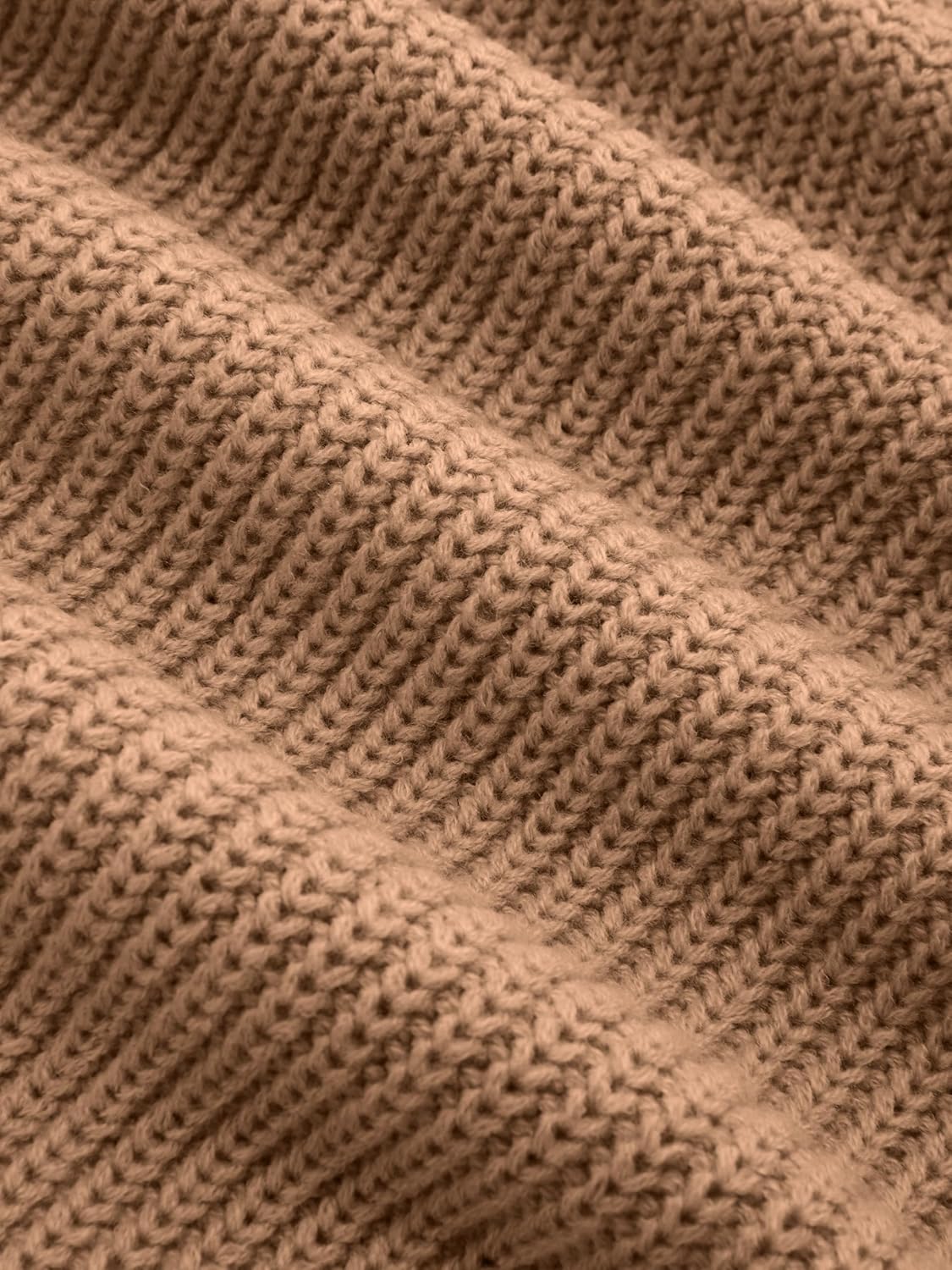 Tan ribbed knit fabric texture close-up, chunky stitch pattern