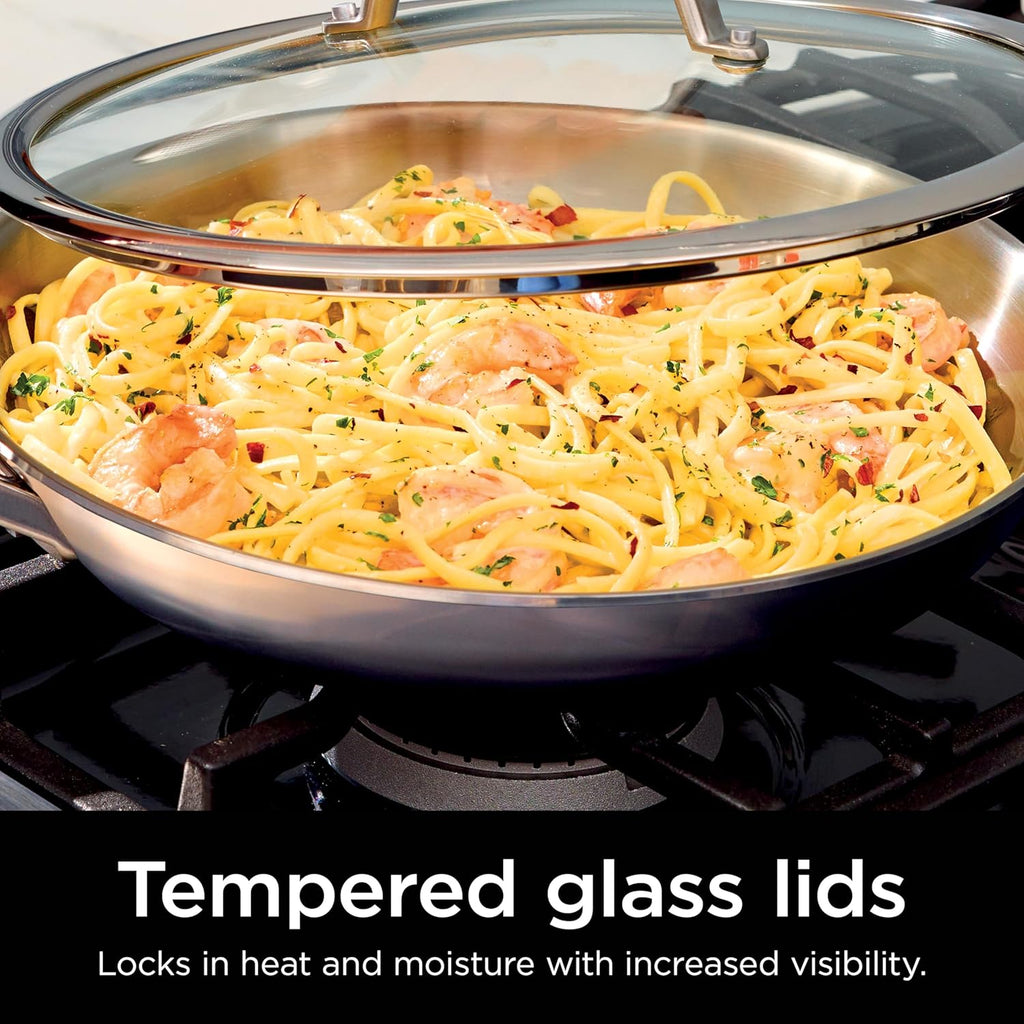 Stainless steel cookware with tempered glass lid, wide pan holding pasta