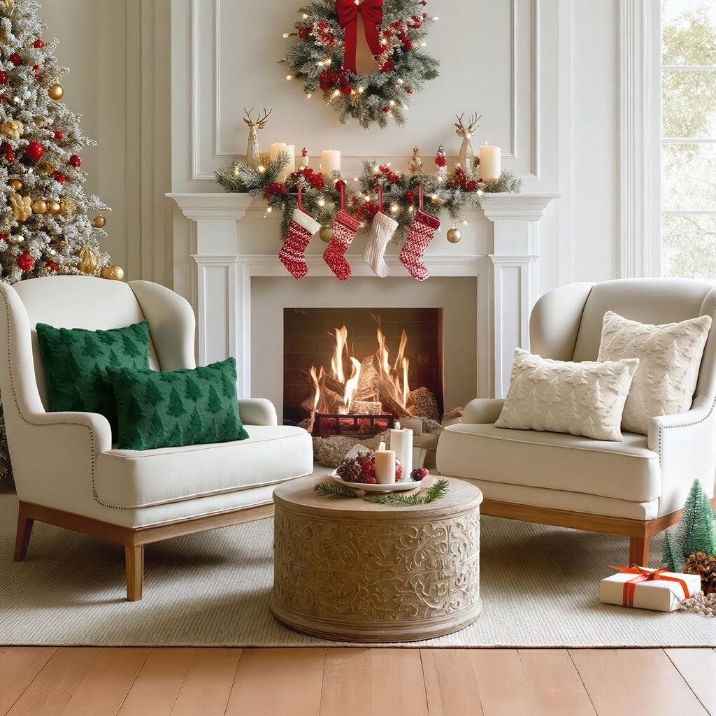 Two dark green Christmas tree pillow covers with one cream pillow beside fire place
