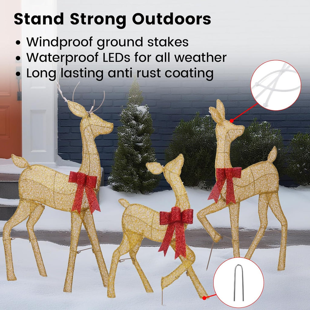 Warm LED-lit gold reindeer family with red bows on ground stakes for outdoors