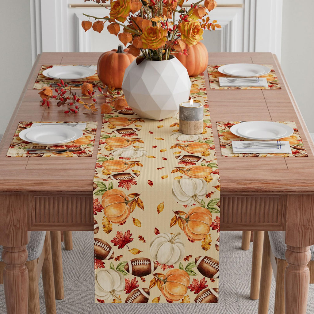 Fall pumpkin and football table runner centered on a dining table