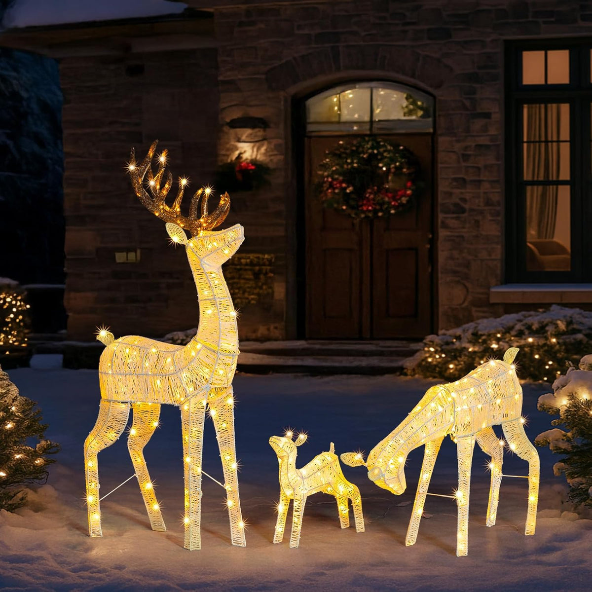Golden pre-lit LED reindeer family lawn decoration with red bows, four figures