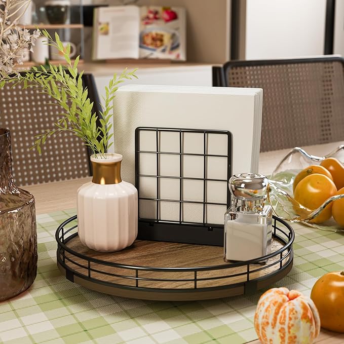 Acacia wood lazy susan turntable on a tabletop with black metal railing and storage jars