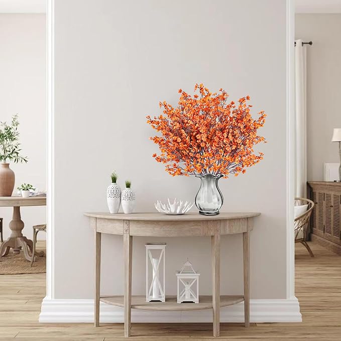 Orange artificial baby's breath bouquet in clear glass vase