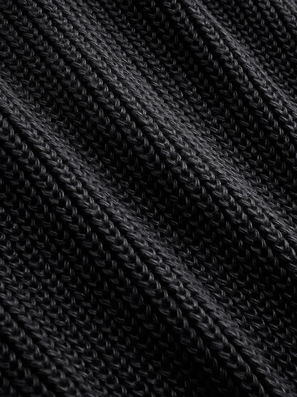 Black ribbed knit texture detail on a women’s mock neck sleeveless sweater vest