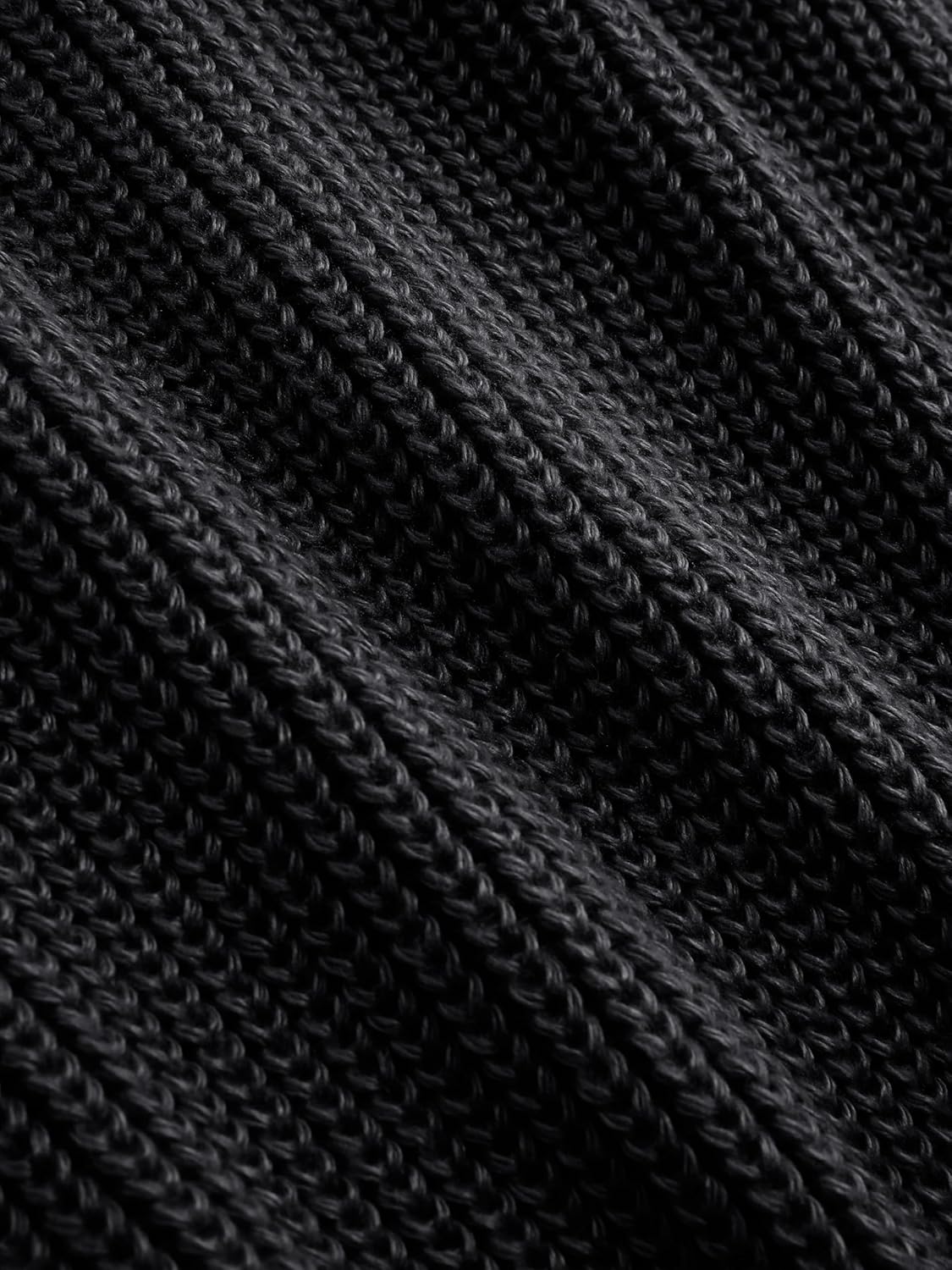 Black ribbed knit texture detail on a women’s mock neck sleeveless sweater vest