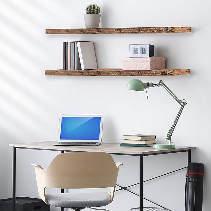 Mahogany floating wall shelves with books, boxes, and a small potted plant