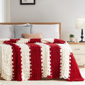 Chunky cable knit throw blanket with red and white vertical stripe pattern