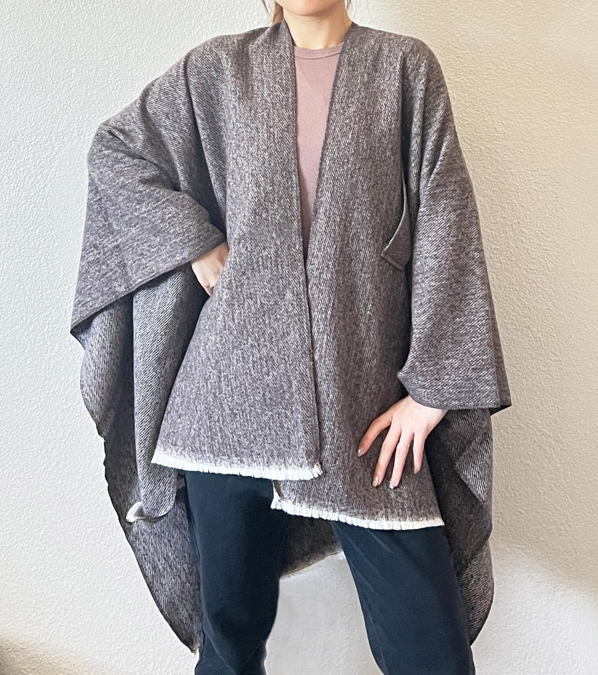 Gray open-front fringe poncho shawl with draped sleeves and stepped hem