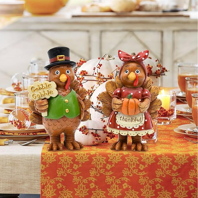 Resin turkey couple figurines on Thanksgiving table with “thankful” apron style outfits.