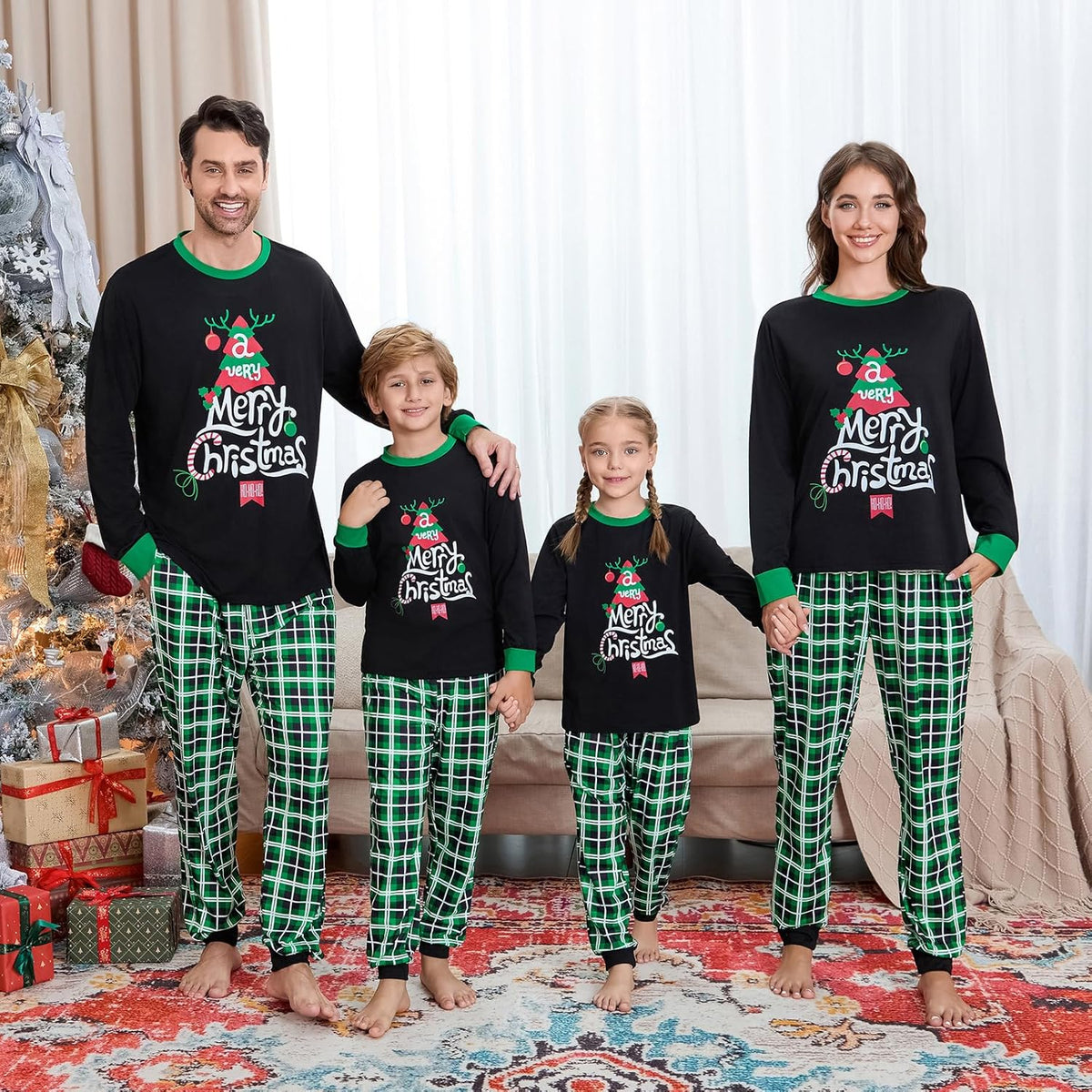 Matching family Christmas pajama set: black long-sleeve tops with green trim and green plaid pants
