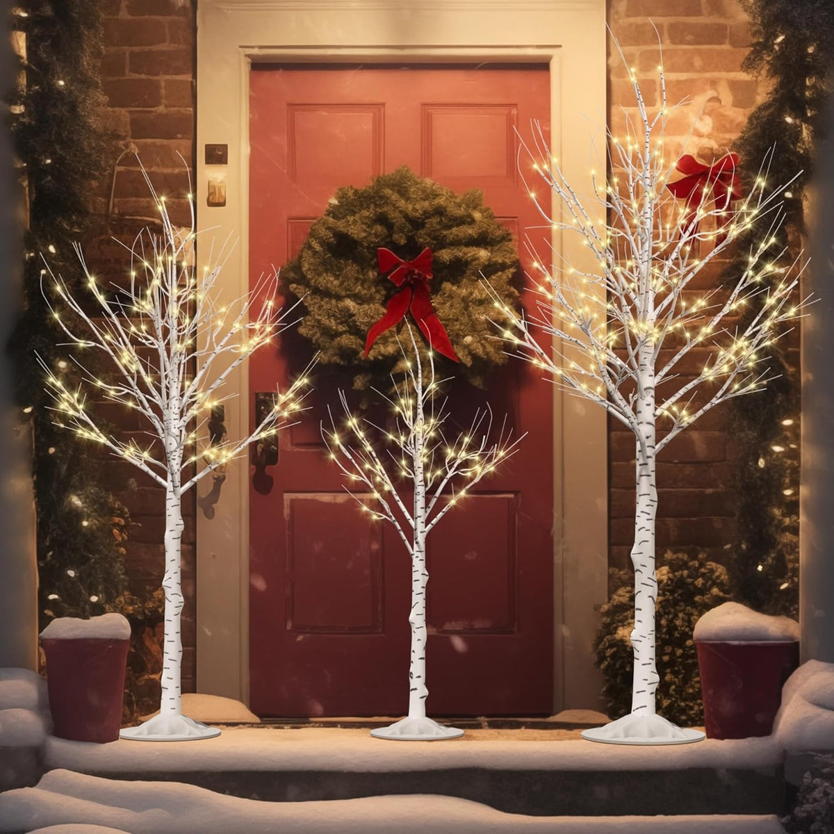 Three lighted birch tree decorations with warm white LEDs and white branch silhouettes