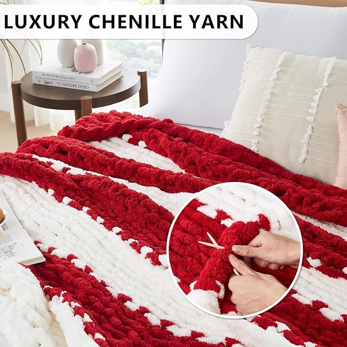 Red and white chunky knitted throw blanket draped across a sofa, textured rows