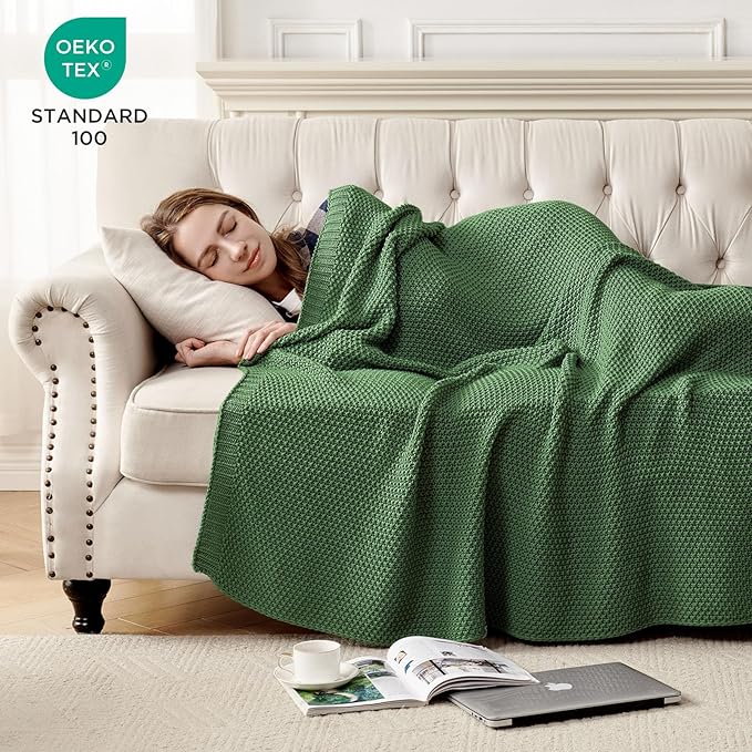 Chunky cable knit cotton throw blanket, olive green, used as bedding cover