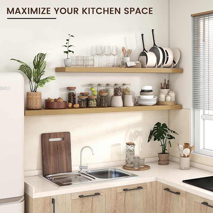 Kitchen wall with two long oak floating shelves holding dishware and jars