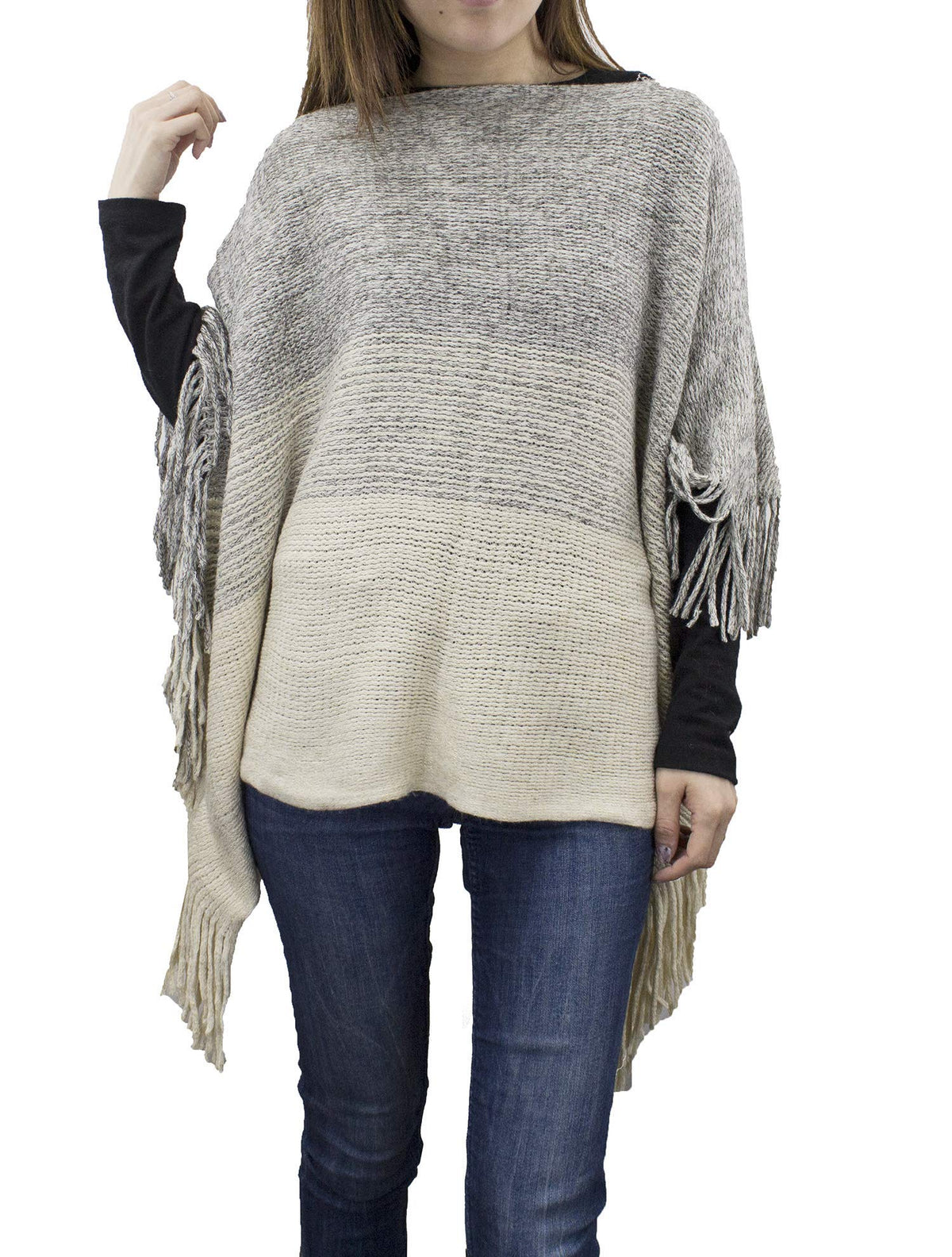 Two-tone fringed knit poncho worn with dark jeans, heather gray and ivory