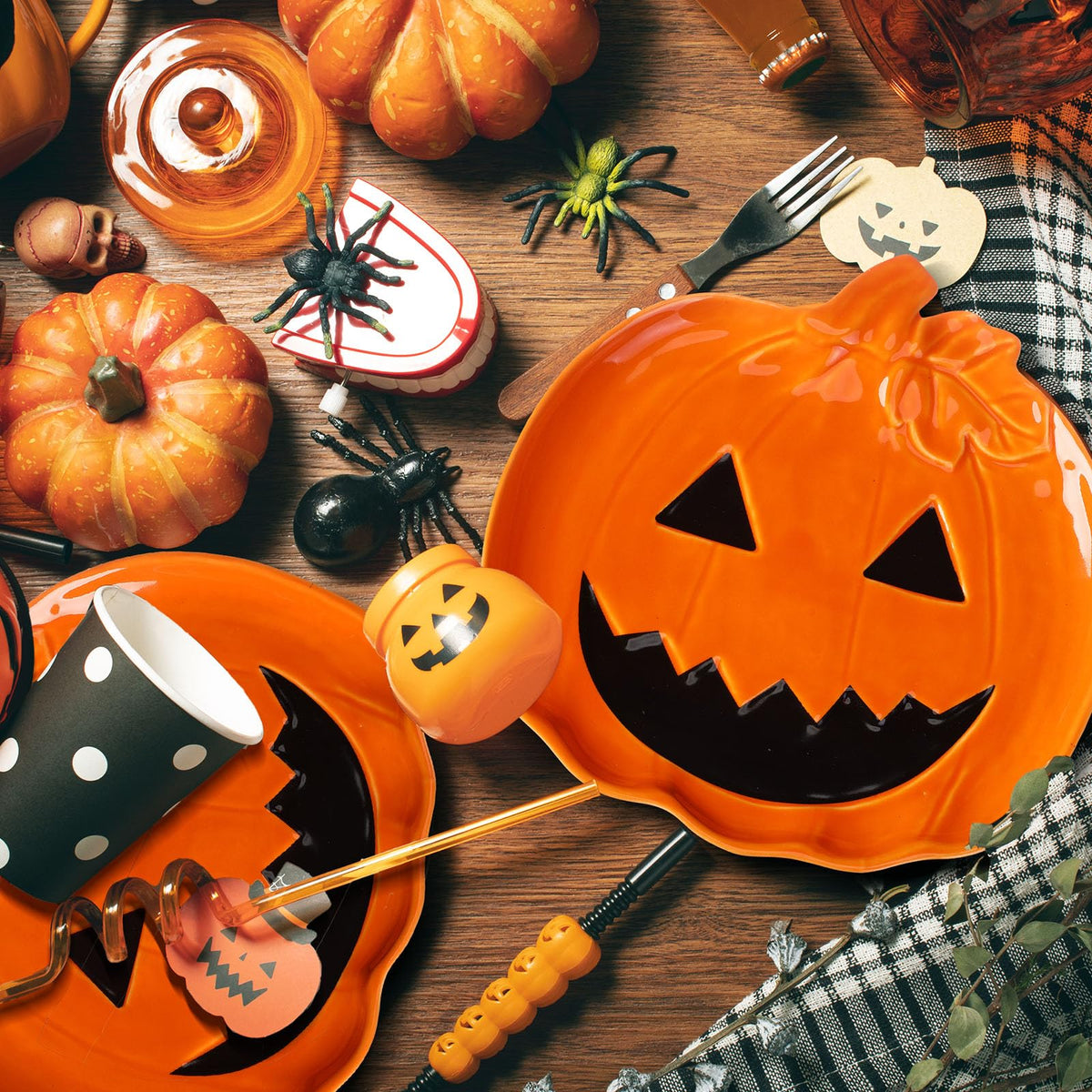 Orange jack-o'-lantern ceramic candy dishes with carved faces