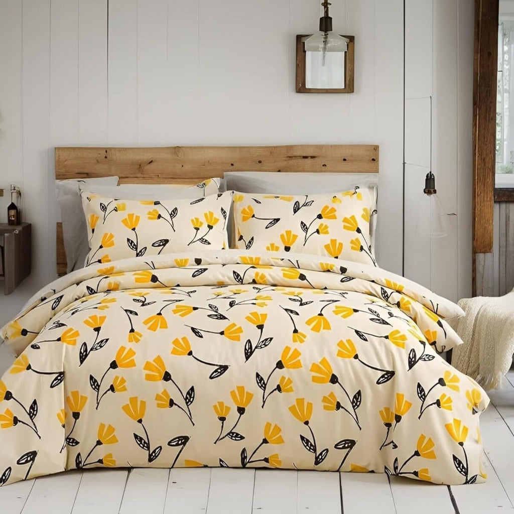 Yellow and black tulip floral duvet cover set on a bed with matching pillow shams