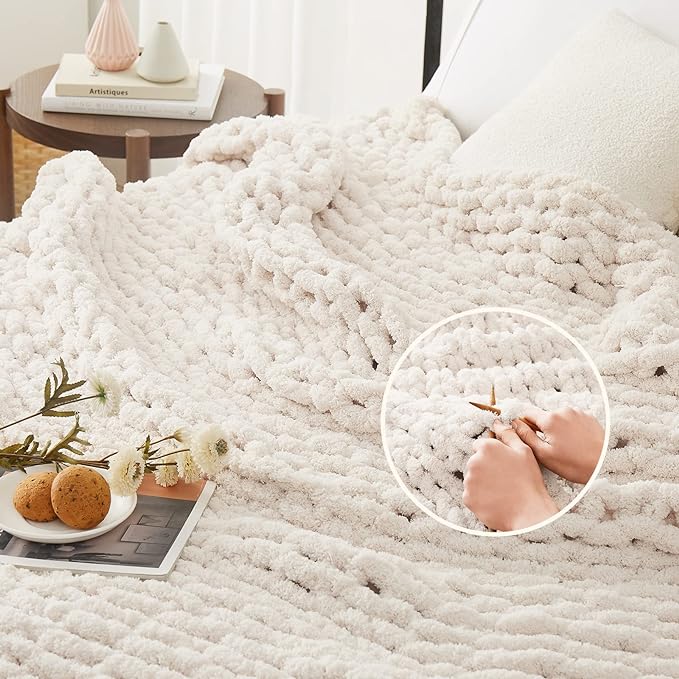 Chunky knit throw blanket in off-white with raised bubble texture on a bed