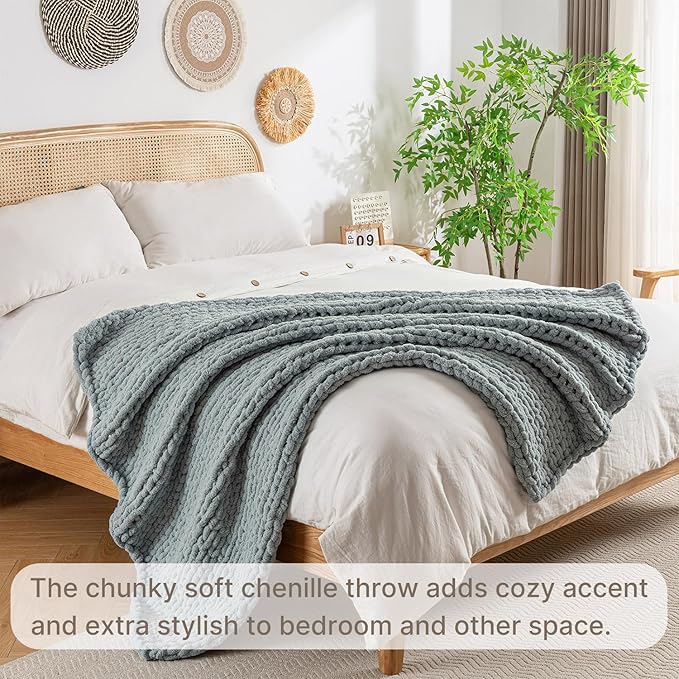 Chunky cable-knit chenille throw blanket in blue over the bed edge
