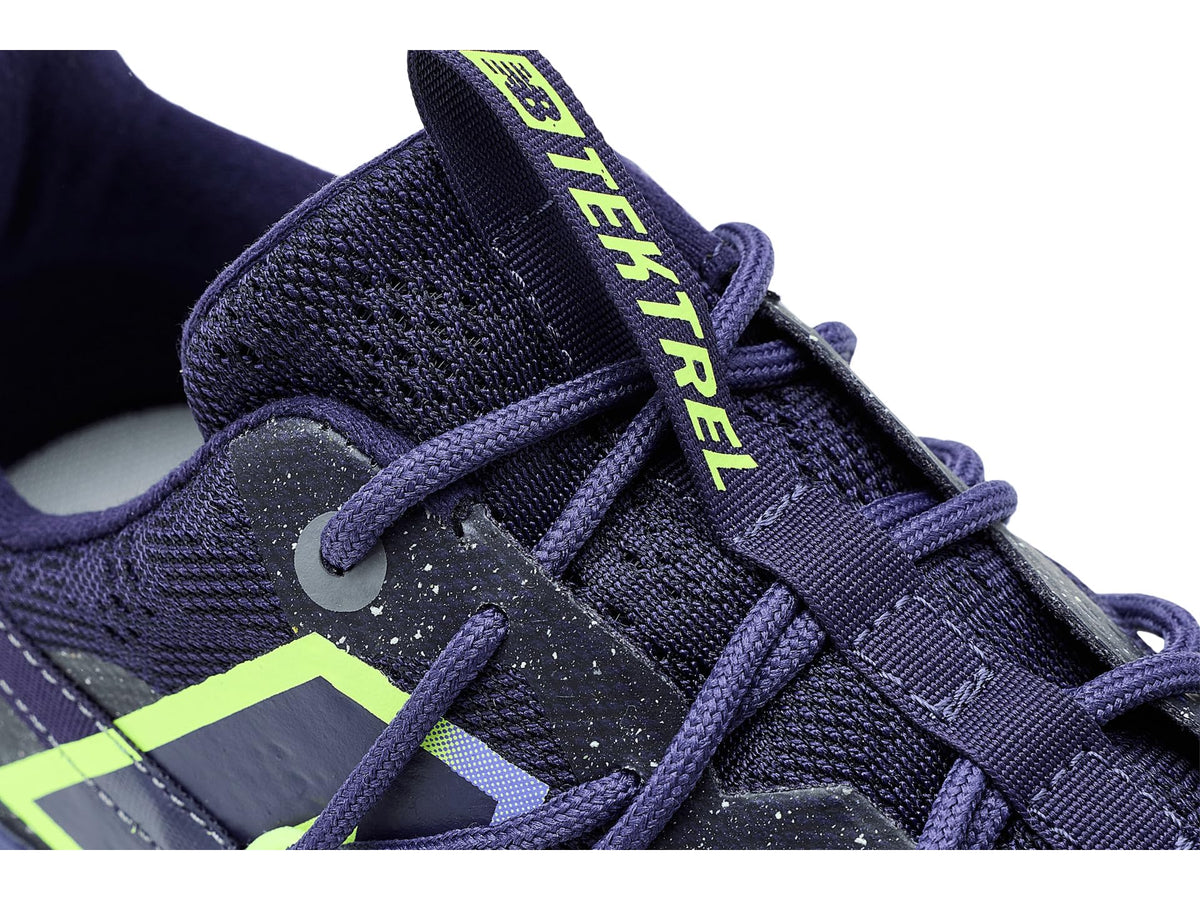 Close-up of navy trail shoe laces and neon green 'N' logo on side