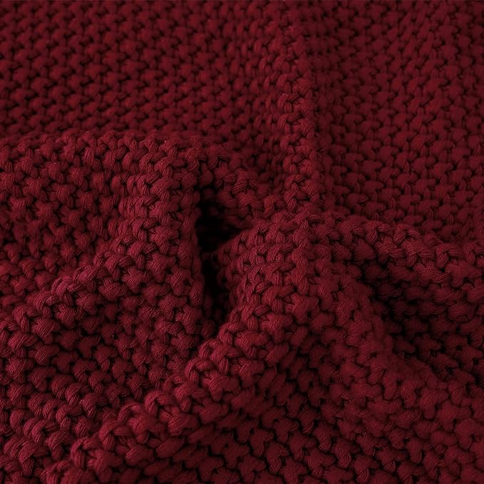 Close-up of burgundy chunky cable-knit throw blanket texture