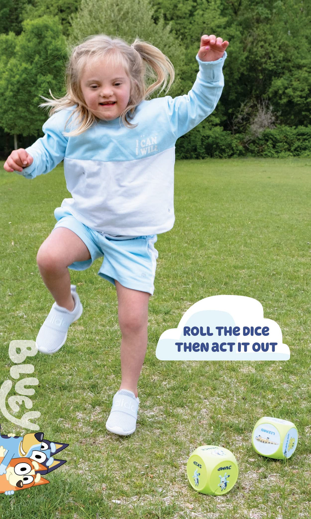 Child holding large blue-and-green action dice for Bluey workout game outdoors.