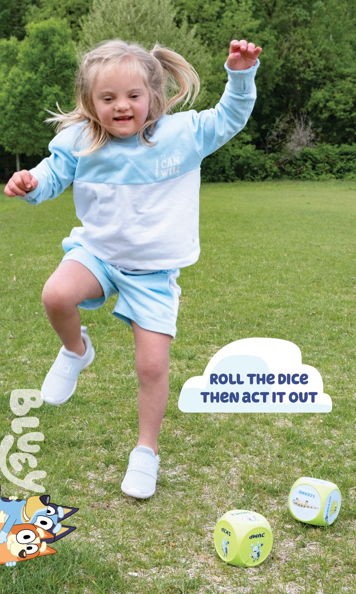 Child holding large blue-and-green action dice for Bluey workout game outdoors.