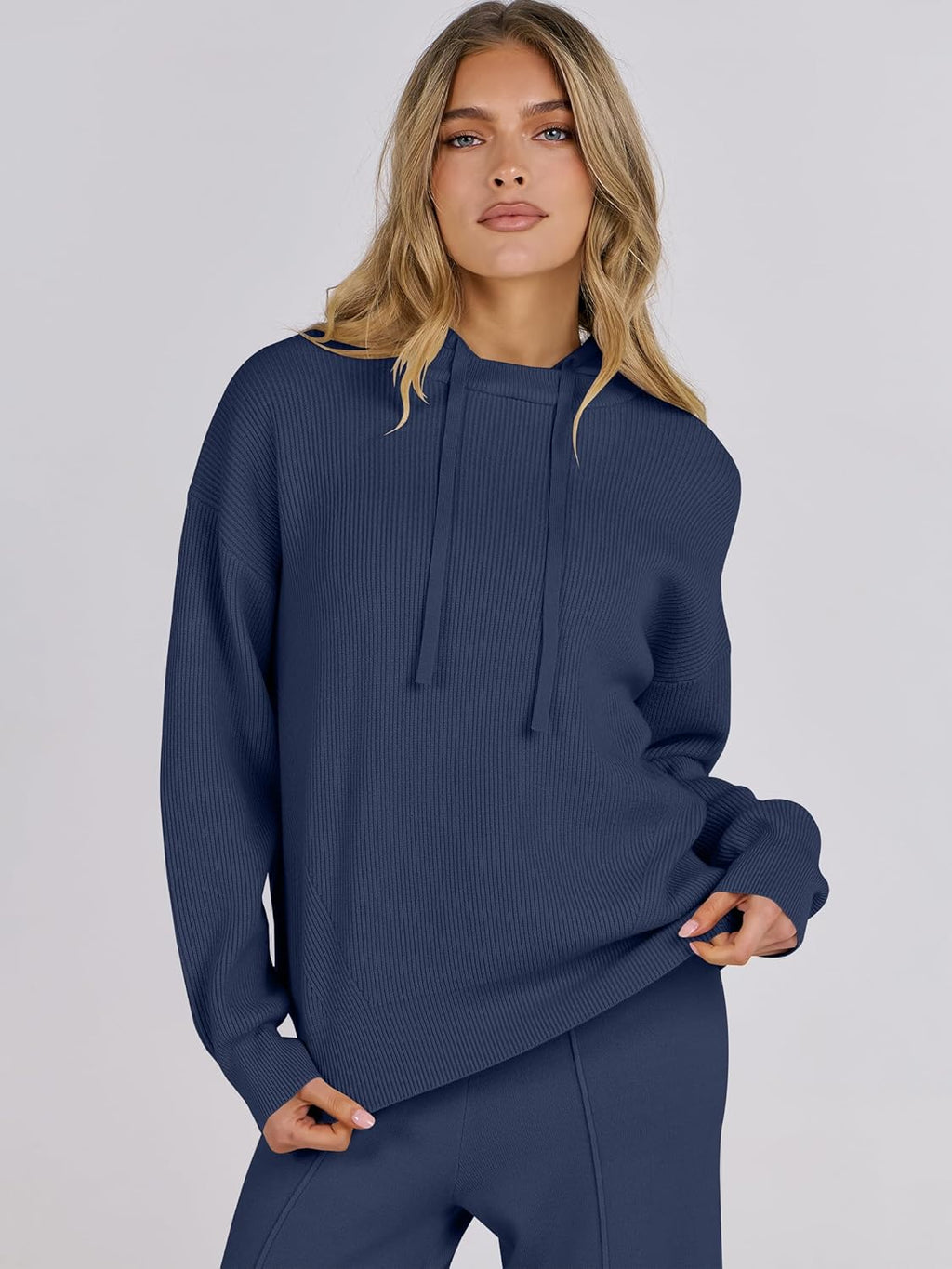 Navy ribbed knit pullover hoodie with drawstring and matching pants, model close-up