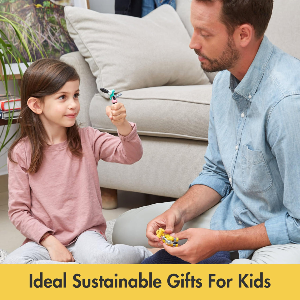 Montessori DIY robot kit, child and adult holding robot parts while assembling on a couch