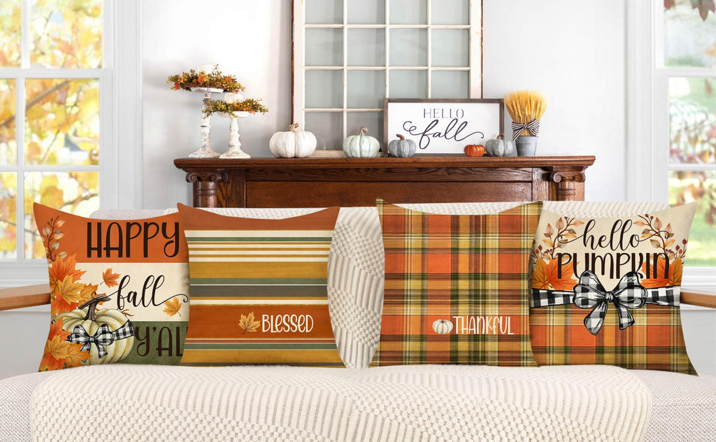 Set of four fall decorative pillow covers with pumpkin, plaid, and striped patterns