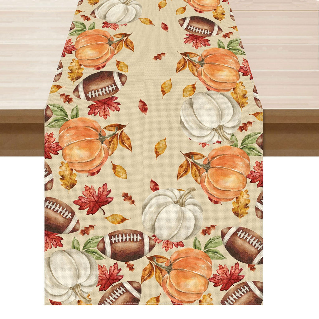Fall pumpkin, maple leaf, and football patterned table runner on light cream fabric