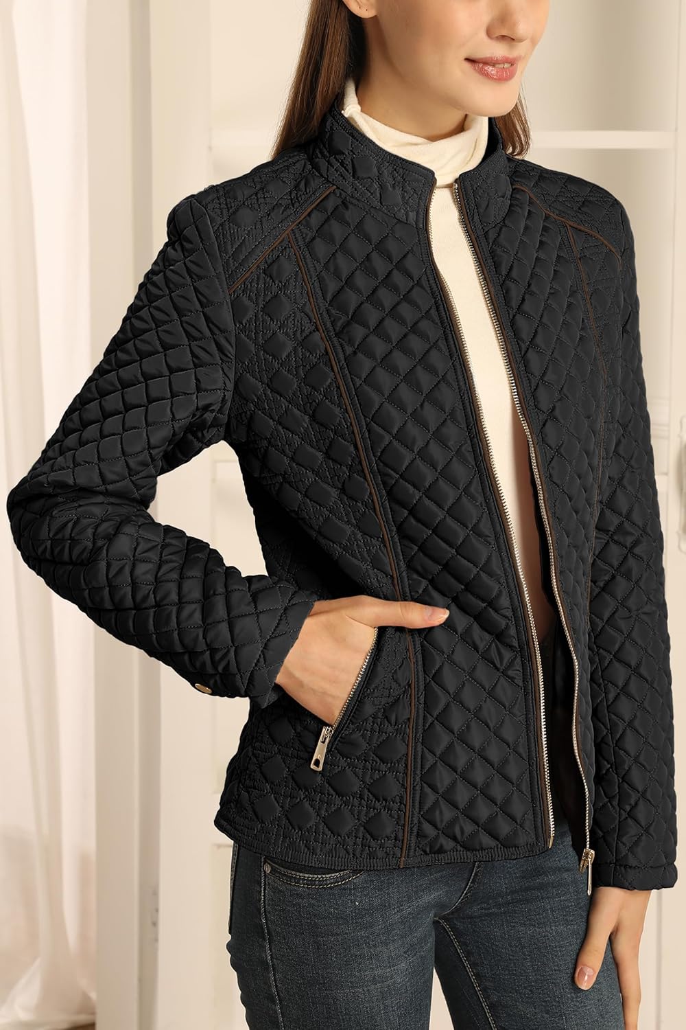 Black quilted puffer jacket with stand collar, front zip, long sleeves, brown piping trim