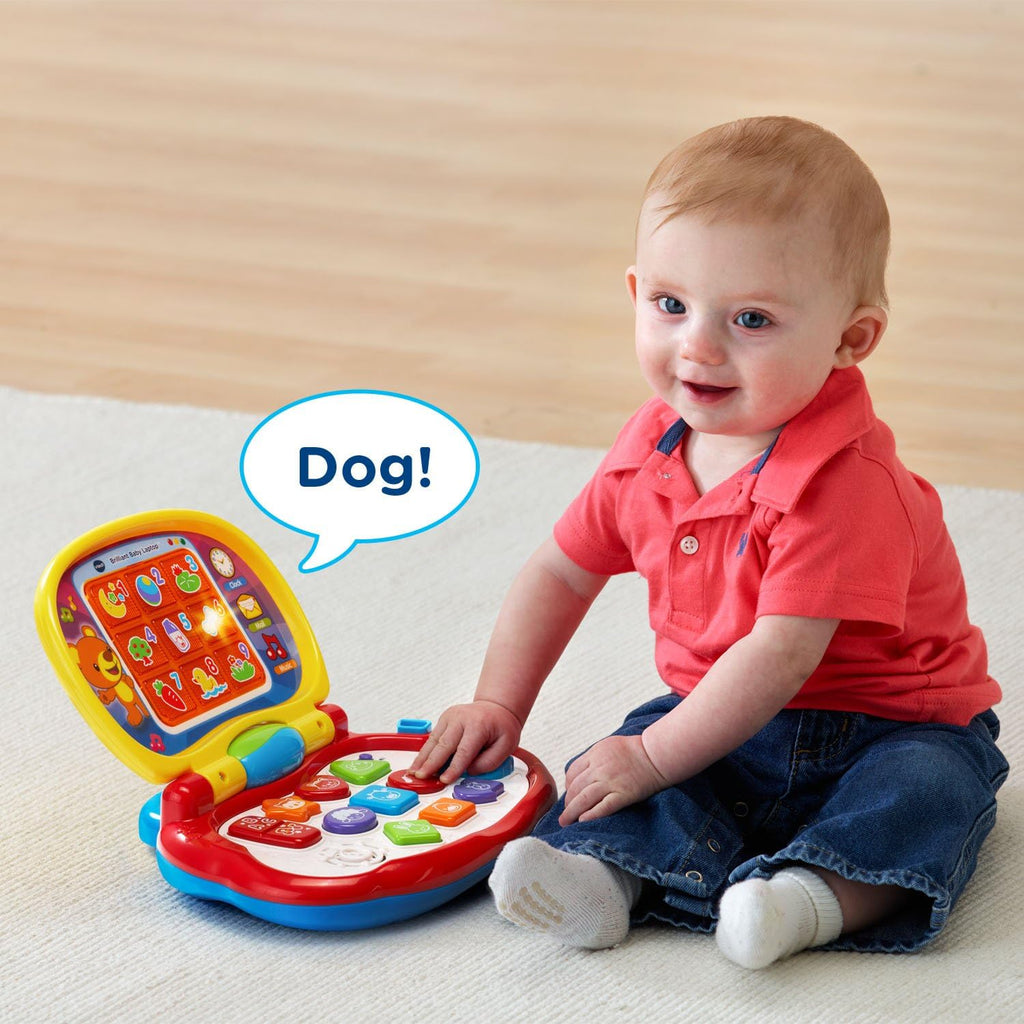 Interactive toddler laptop toy with colorful keys and animal pictures, held by a child.