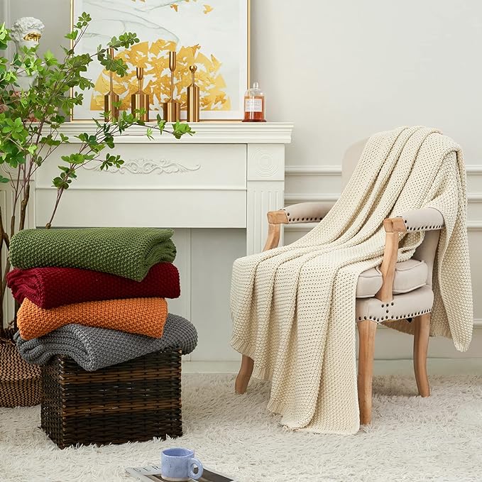 Burgundy chunky cable-knit throw blanket draped over a chair