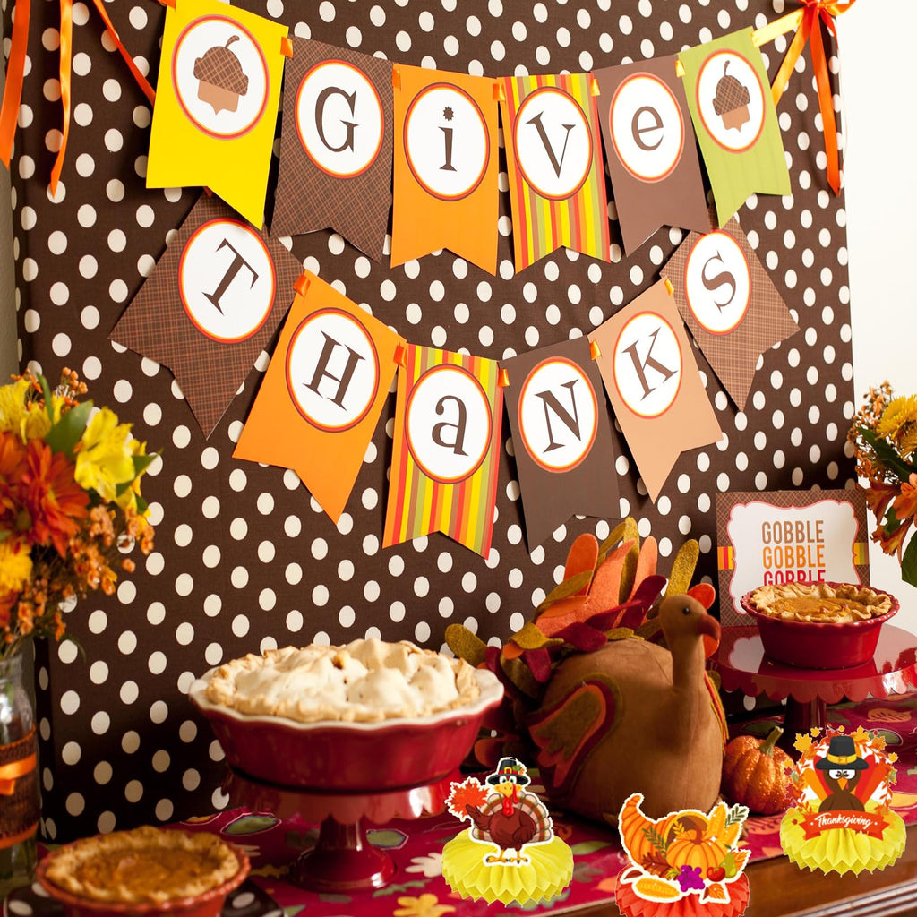 Thanksgiving party banner with polka dots and honeycomb centerpieces with turkey and pumpkin