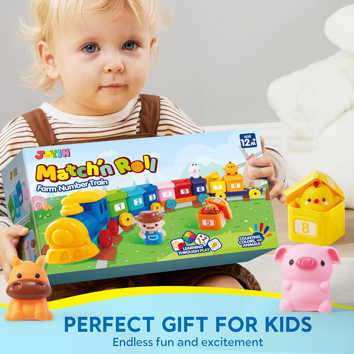 Toddler holding farm number train box with colorful train and animal toy pieces
