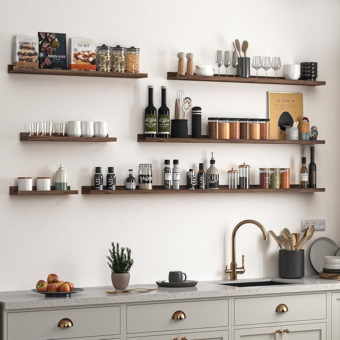 Walnut wall-mounted ledge shelves set of 2 for organizing books, bottles, and kitchen items.