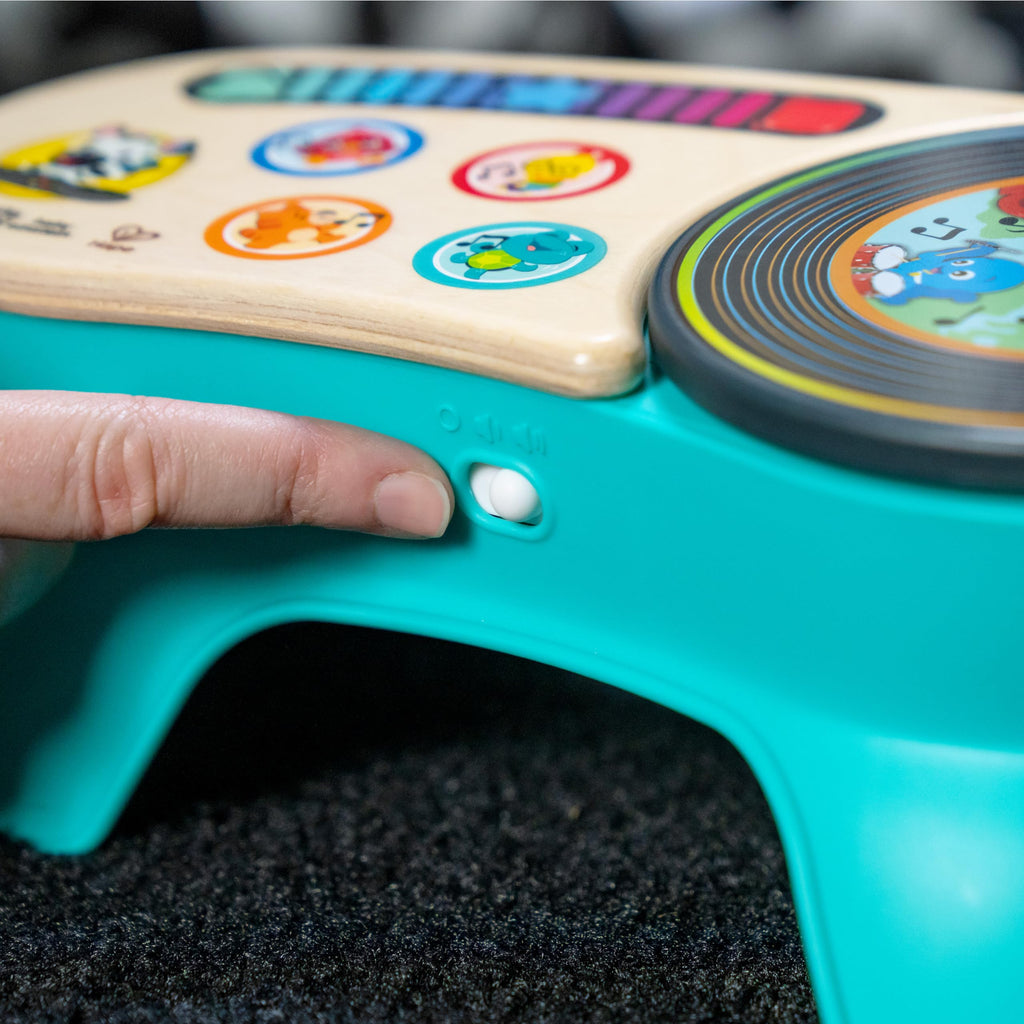 Close-up of teal discovery stool corner with wooden panel and circular rotating dial