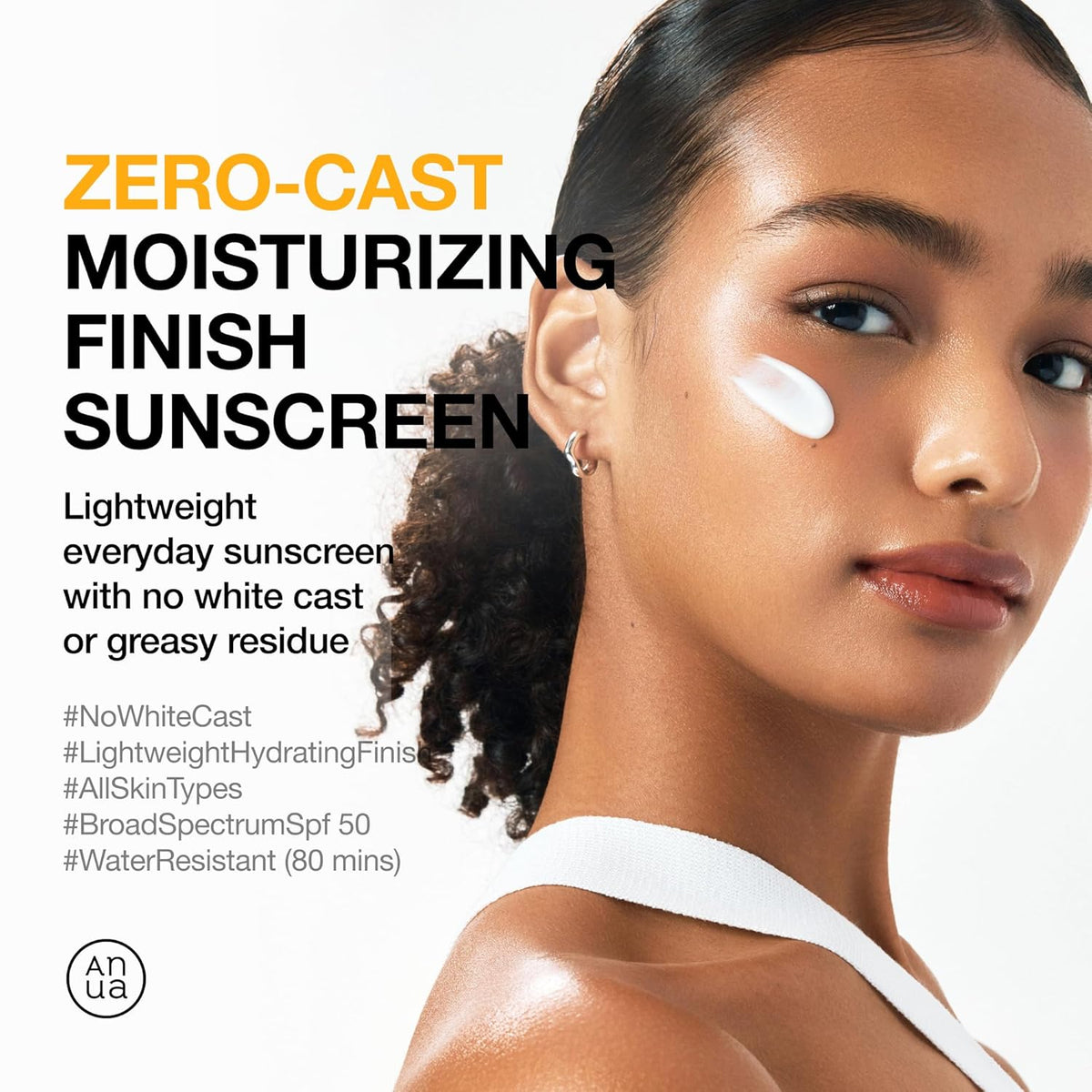 ANUA sunscreen SPF50+ PA++++ on face, white cream smear on cheek and forehead