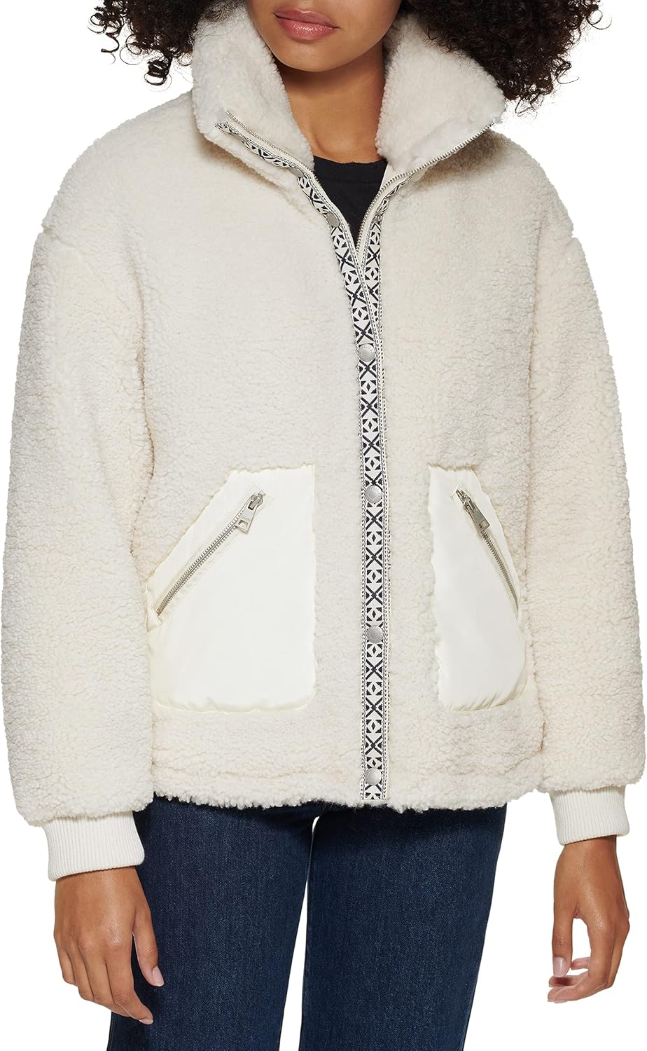 Cream sherpa teddy jacket with zip front, stand collar, and two zipper chest pockets