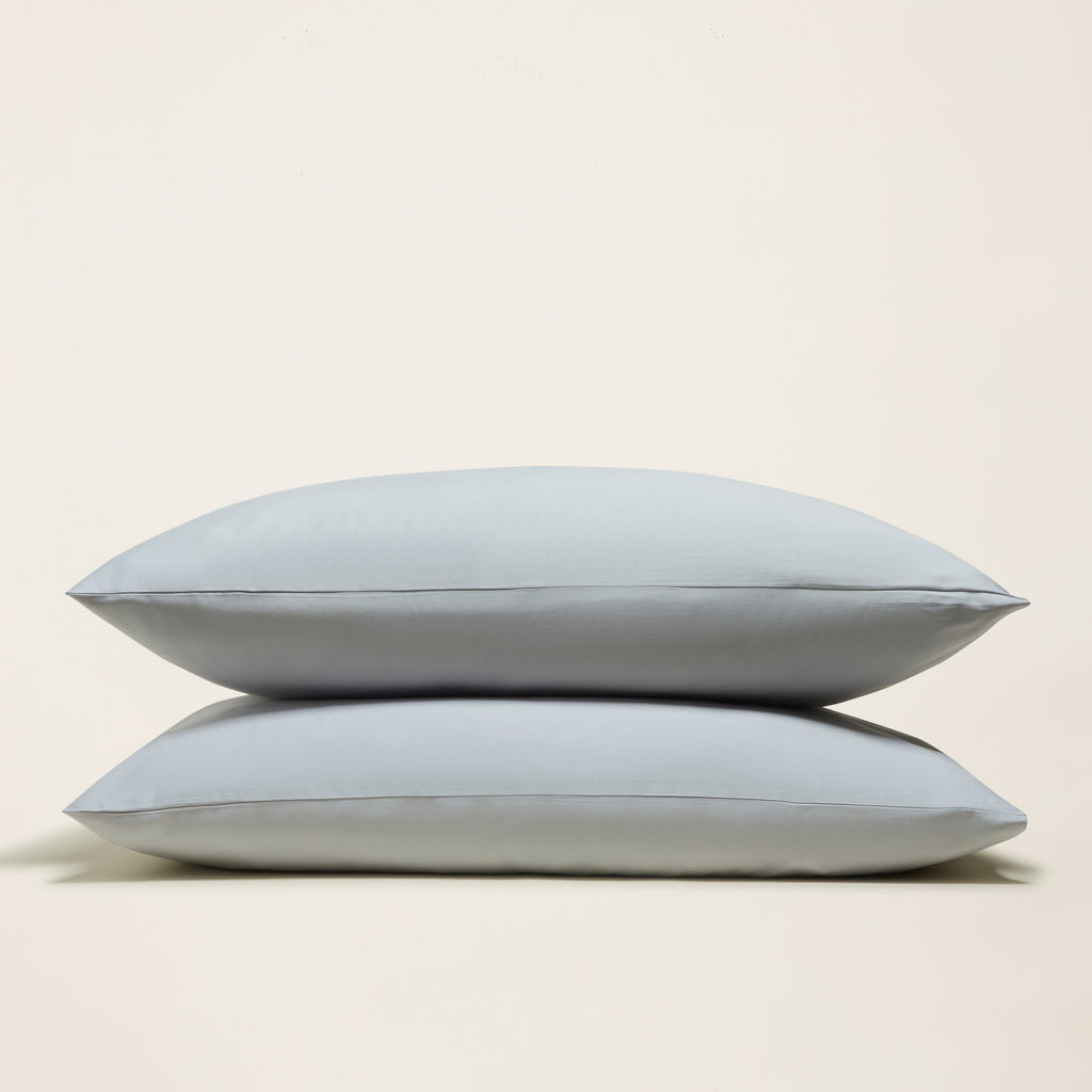 Light blue sateen sheet set with two folded pillowcases stacked