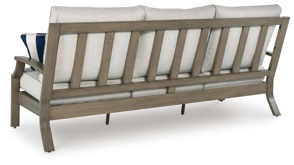 Outdoor sofa with light gray back cushions and dark wood frame
