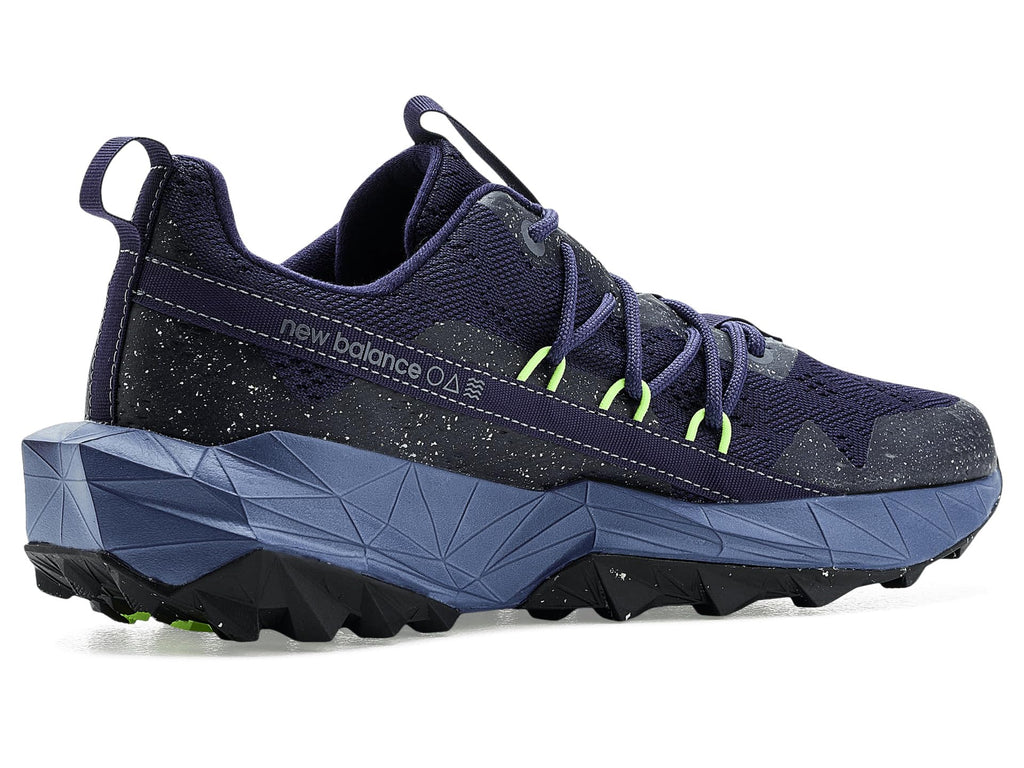 Navy trail running shoe with neon green trim, chunky geometric midsole and rugged outsole